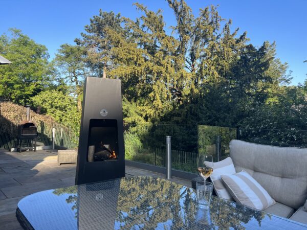 Luxury Metal Chiminea whole with trees in back ground no people
